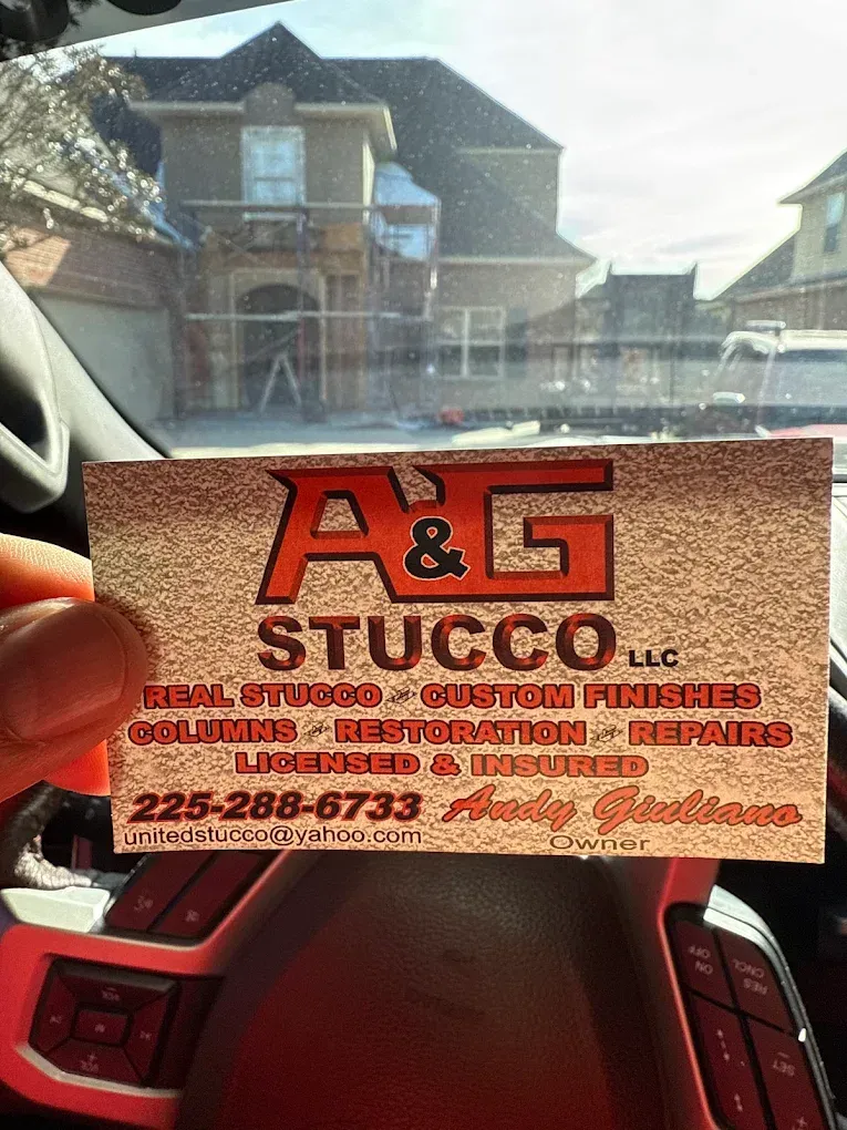 A hand holding a business card for