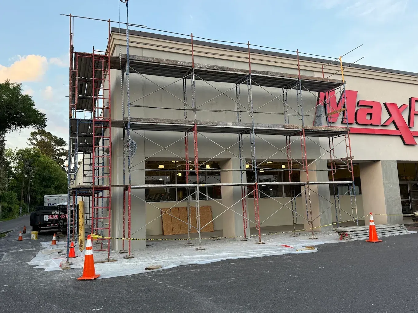 Exterior of a Max Home store under construction, with scaffolding and cones blocking the entrance.