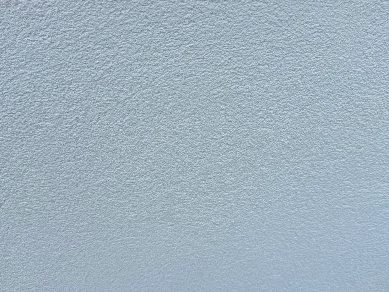 Light blue textured wall.