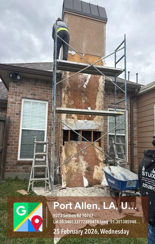 Person on scaffolding repairing a brick chimney in Port Allen, LA.