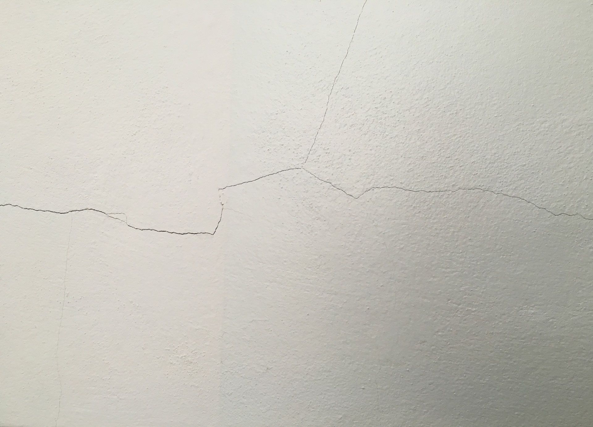 Orange tile roof against a bright blue sky with a hint of white clouds.