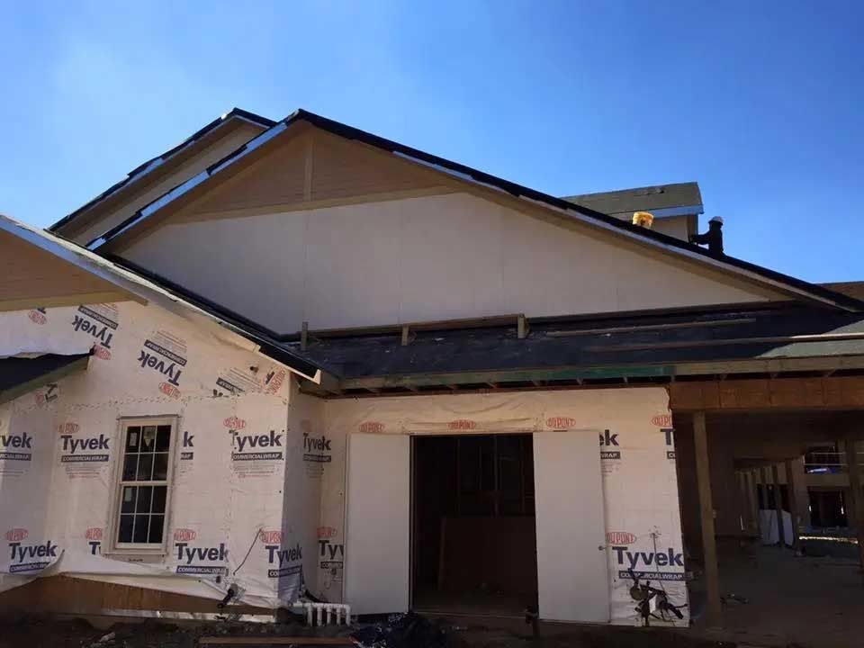 A house that is being built with styrofoam on the walls.
