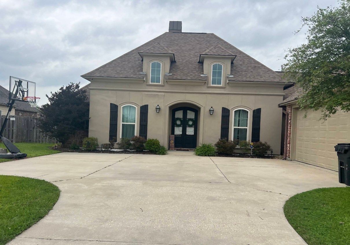 A large house with a basketball hoop in front of it.
