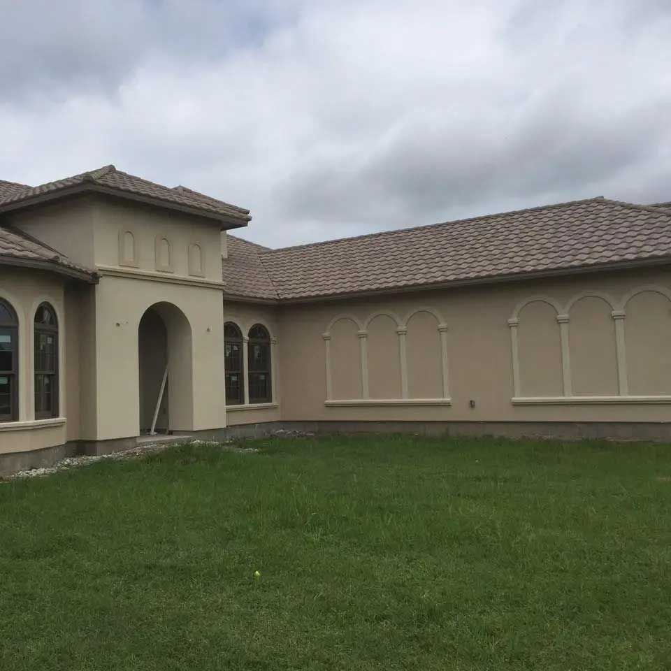 A large house with a large lawn in front of it.