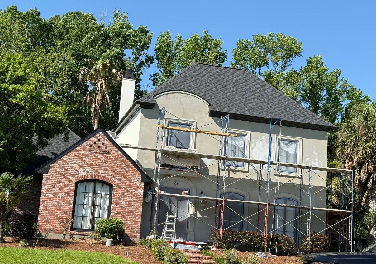 A house with scaffolding around it is being painted.