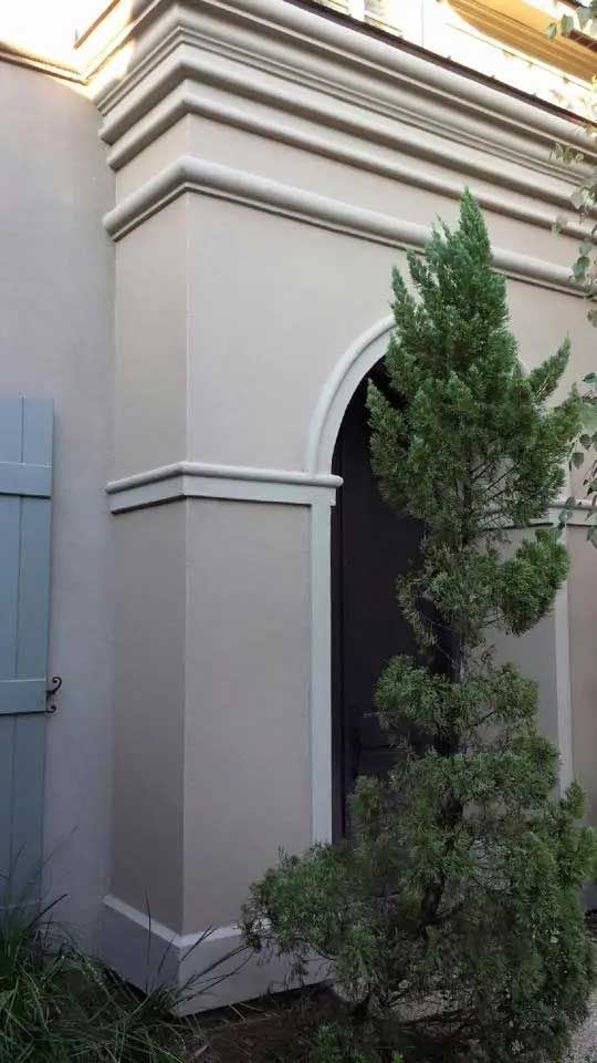 A building with a tree in front of it and a door.