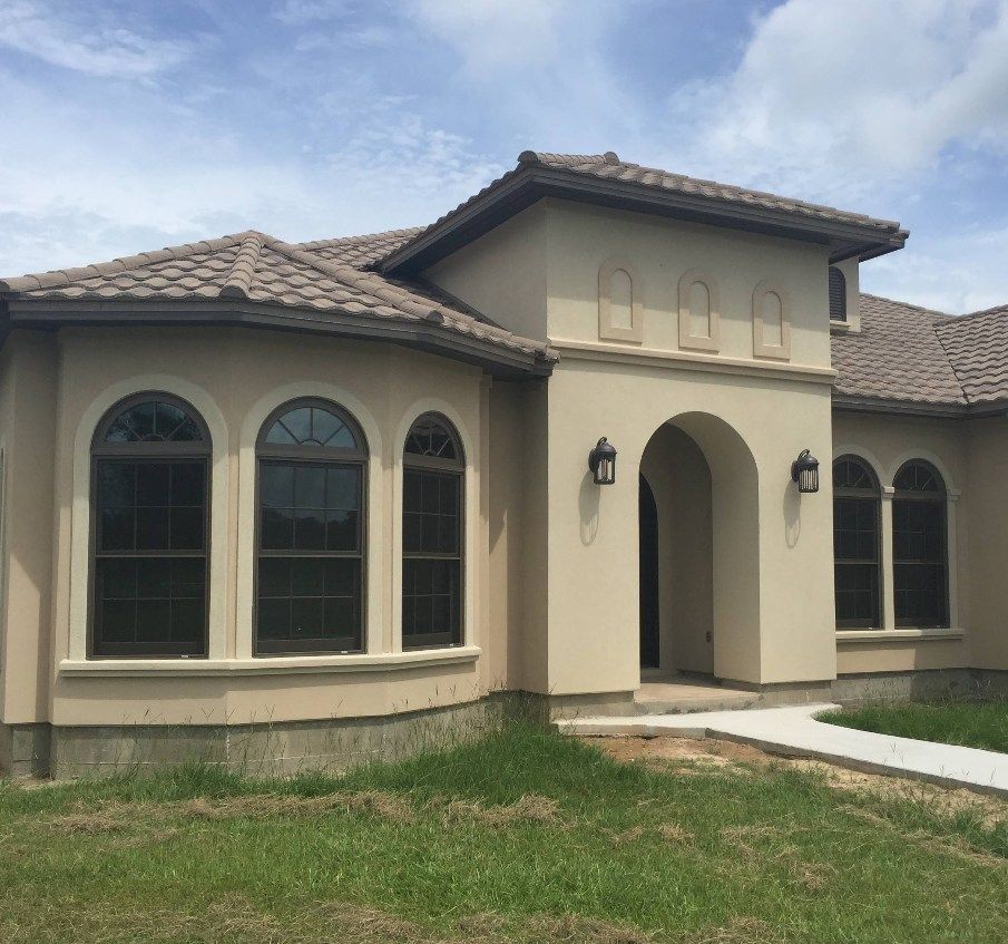 A house with arched windows and a tiled roof.