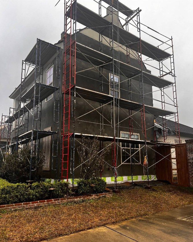 A house is being remodeled with scaffolding around it.
