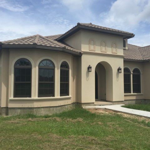 A large house with arched windows and a roof.