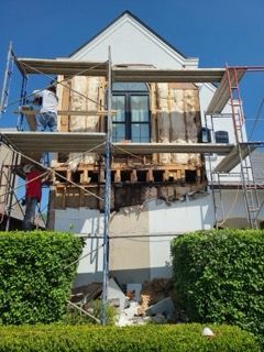 A house is being remodeled with scaffolding around it.