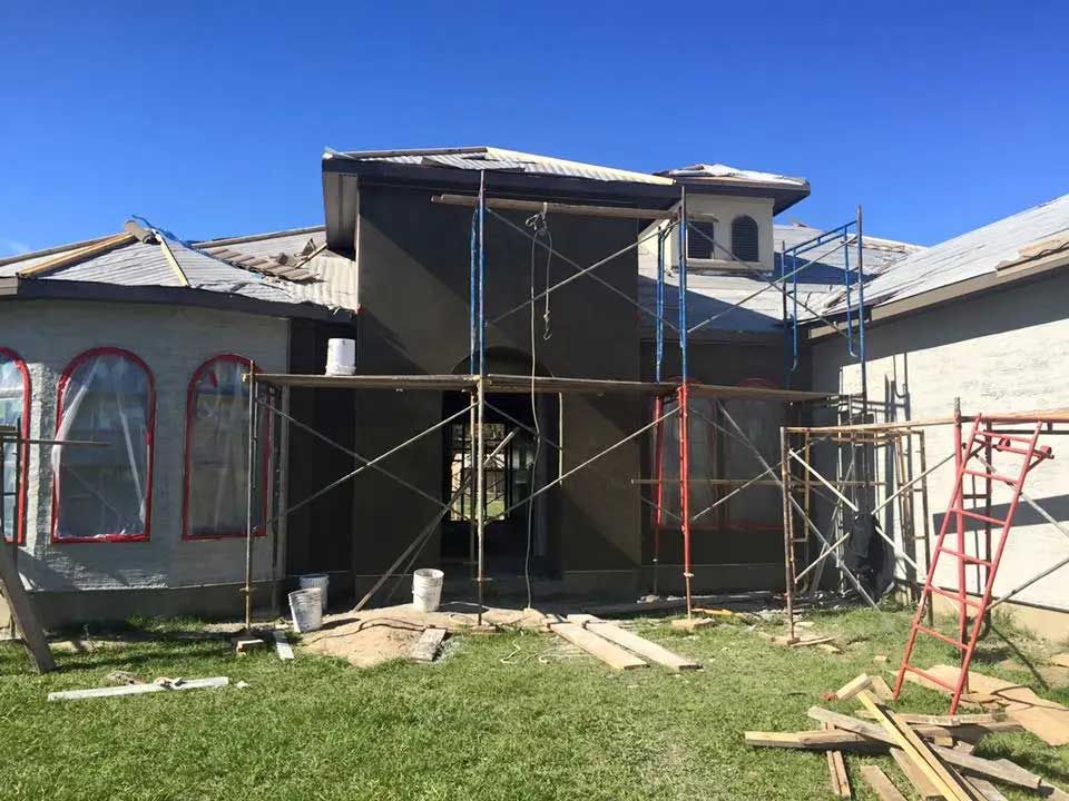 A house is being built with scaffolding around it.