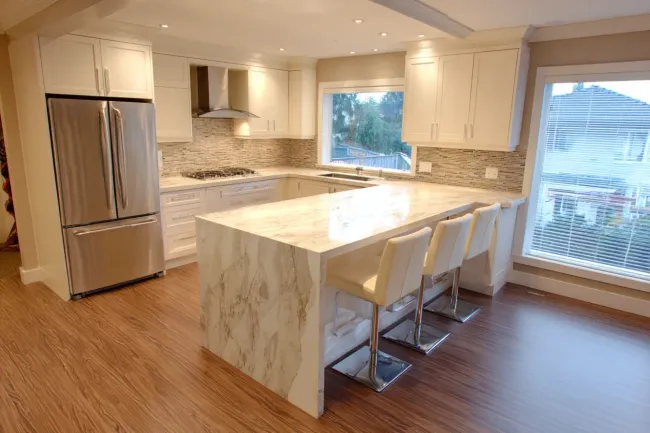 Kitchen renovation Coquitlam BC | Kitchen remodeling Coquitlam Canada | Open layouts with waterfall quartz islands and matte cabinetry. Local builders integrate lighting, ventilation, and custom cabinetry. Coquitlam renovations create inviting spaces built to last.