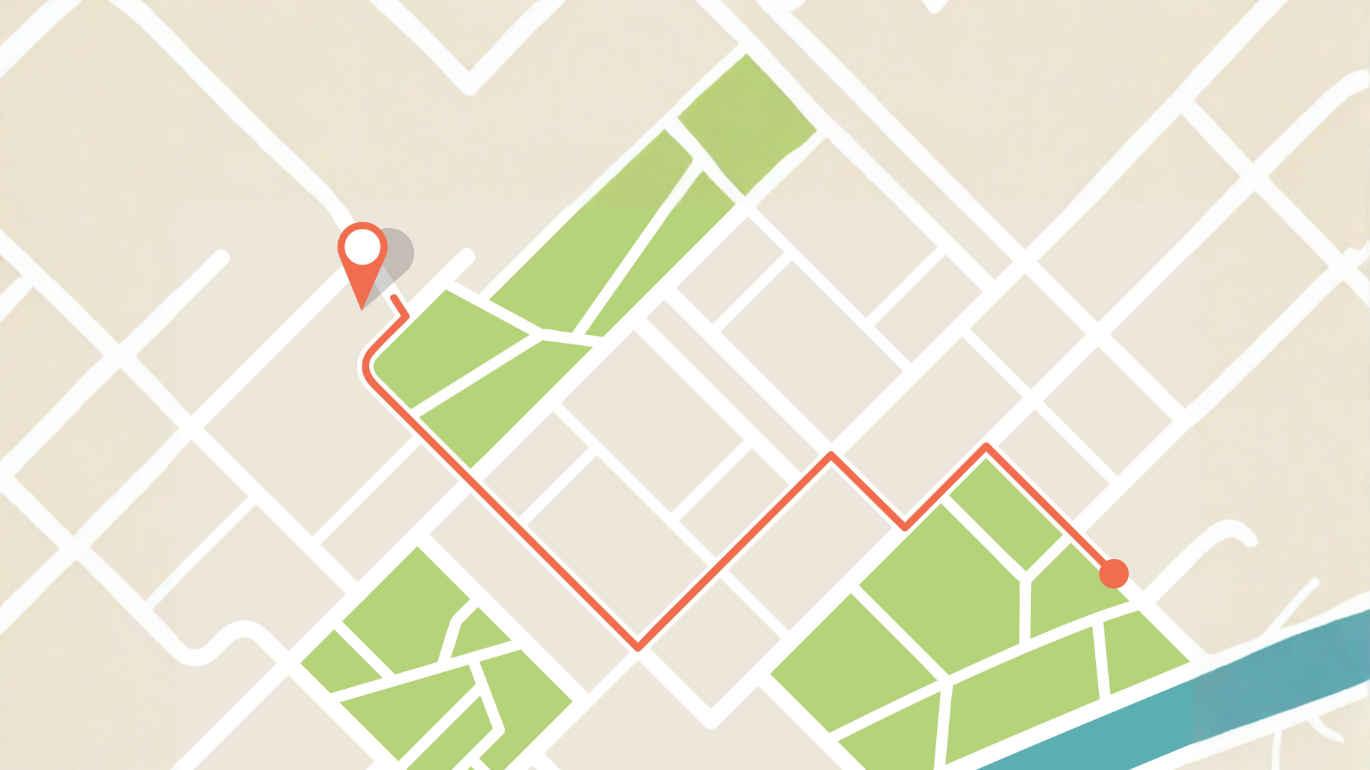 Map with a red route line and two location pins through green park blocks and streets near a waterfront.