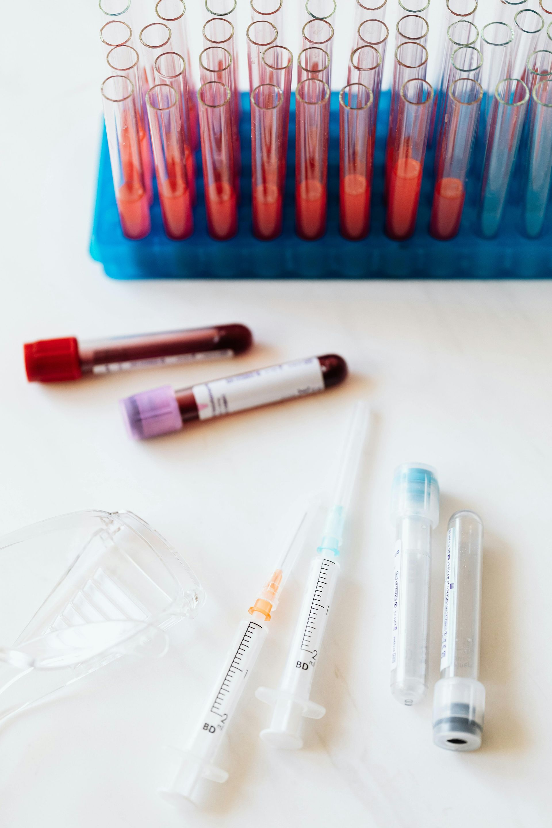 A bunch of test tubes and syringes on a table