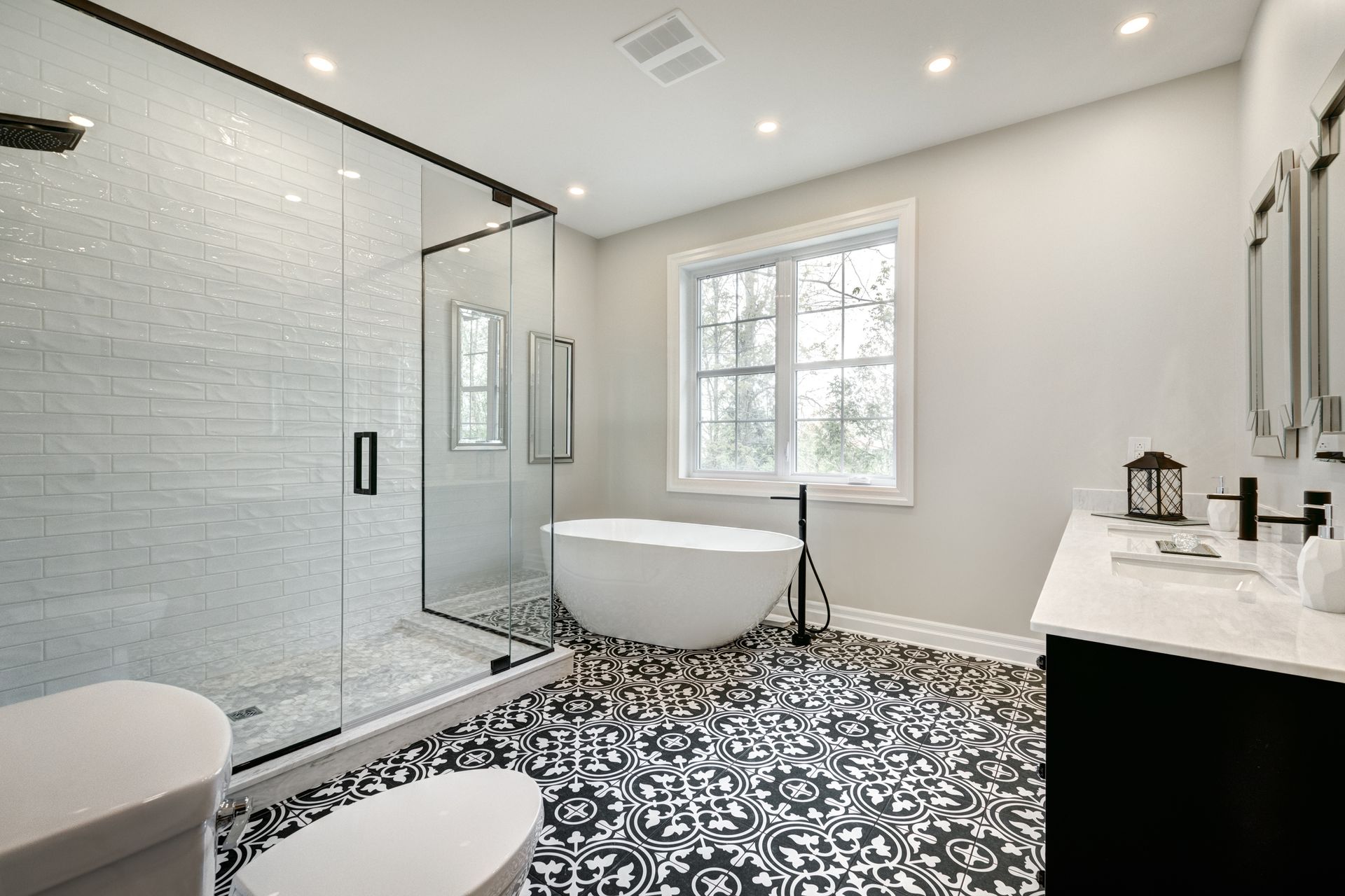 A bathroom with a tub , toilet , sink and shower.