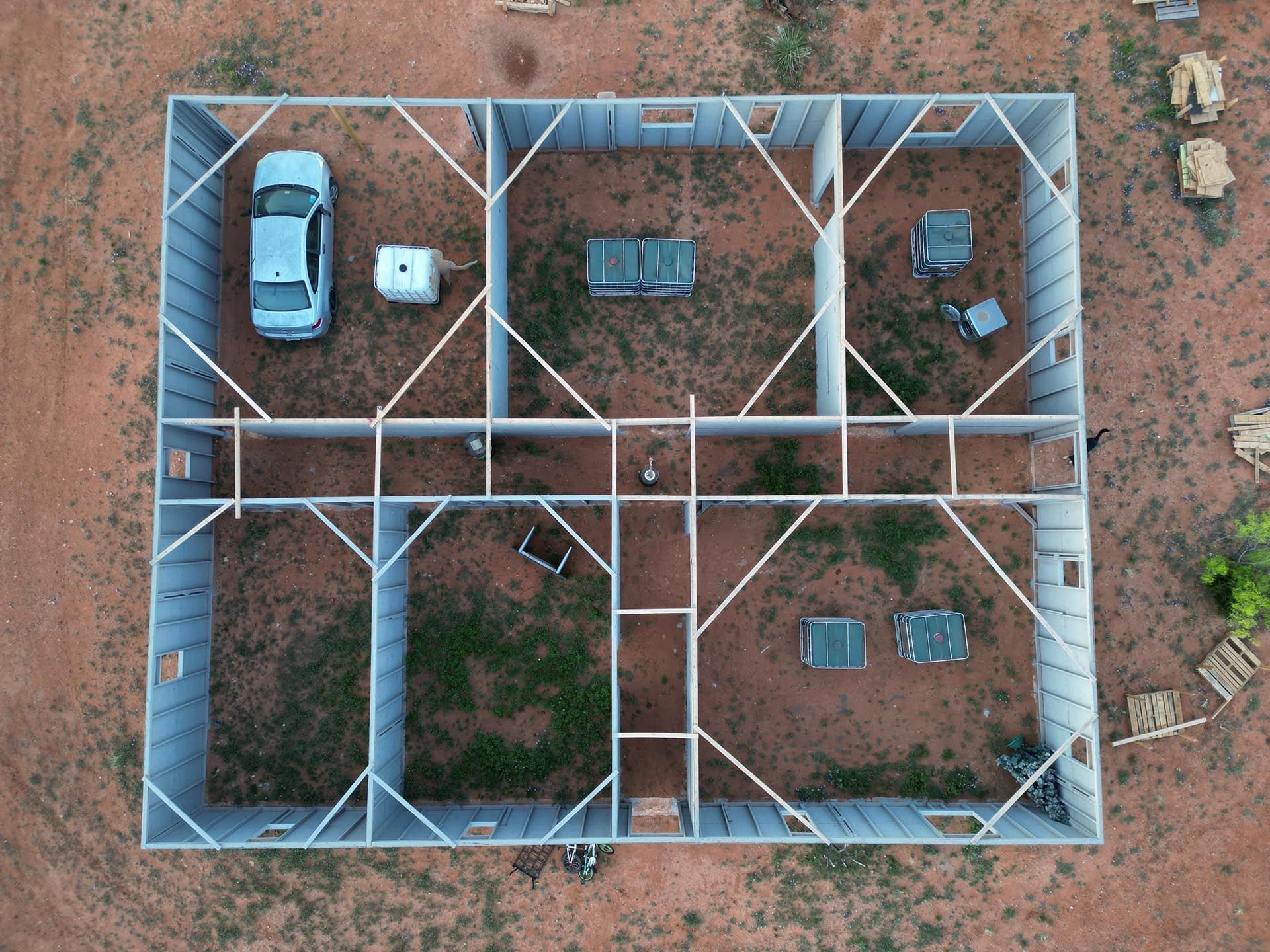 An aerial view of a building with a car parked in the middle