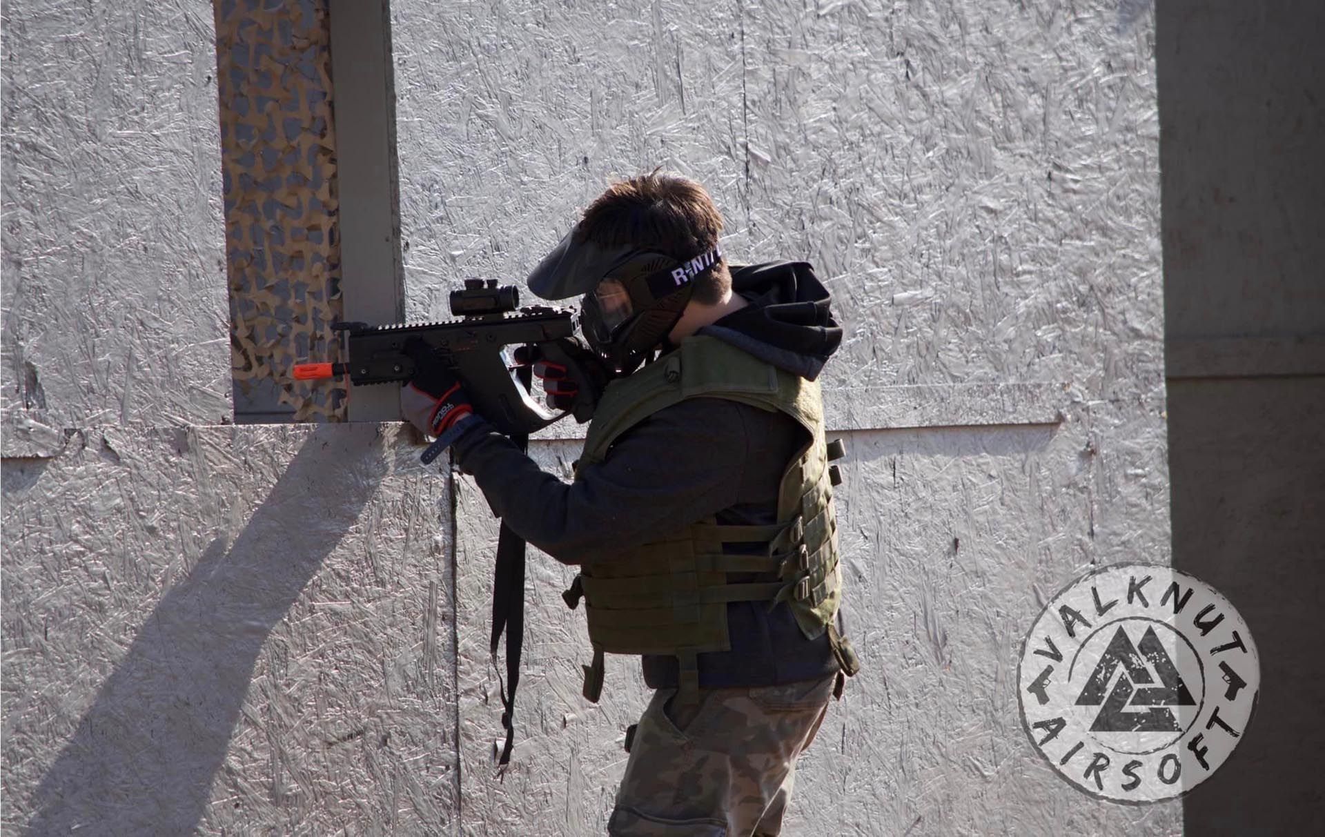 Airsoft player aiming at the window