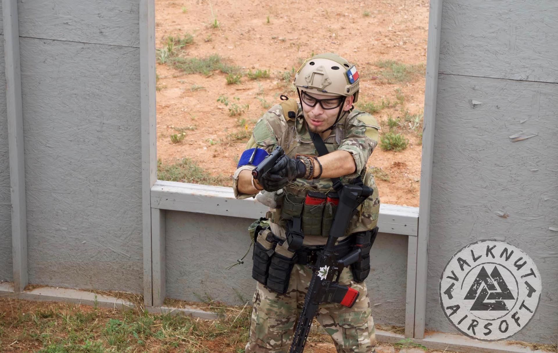 Airsoft player aiming gun at his opponent