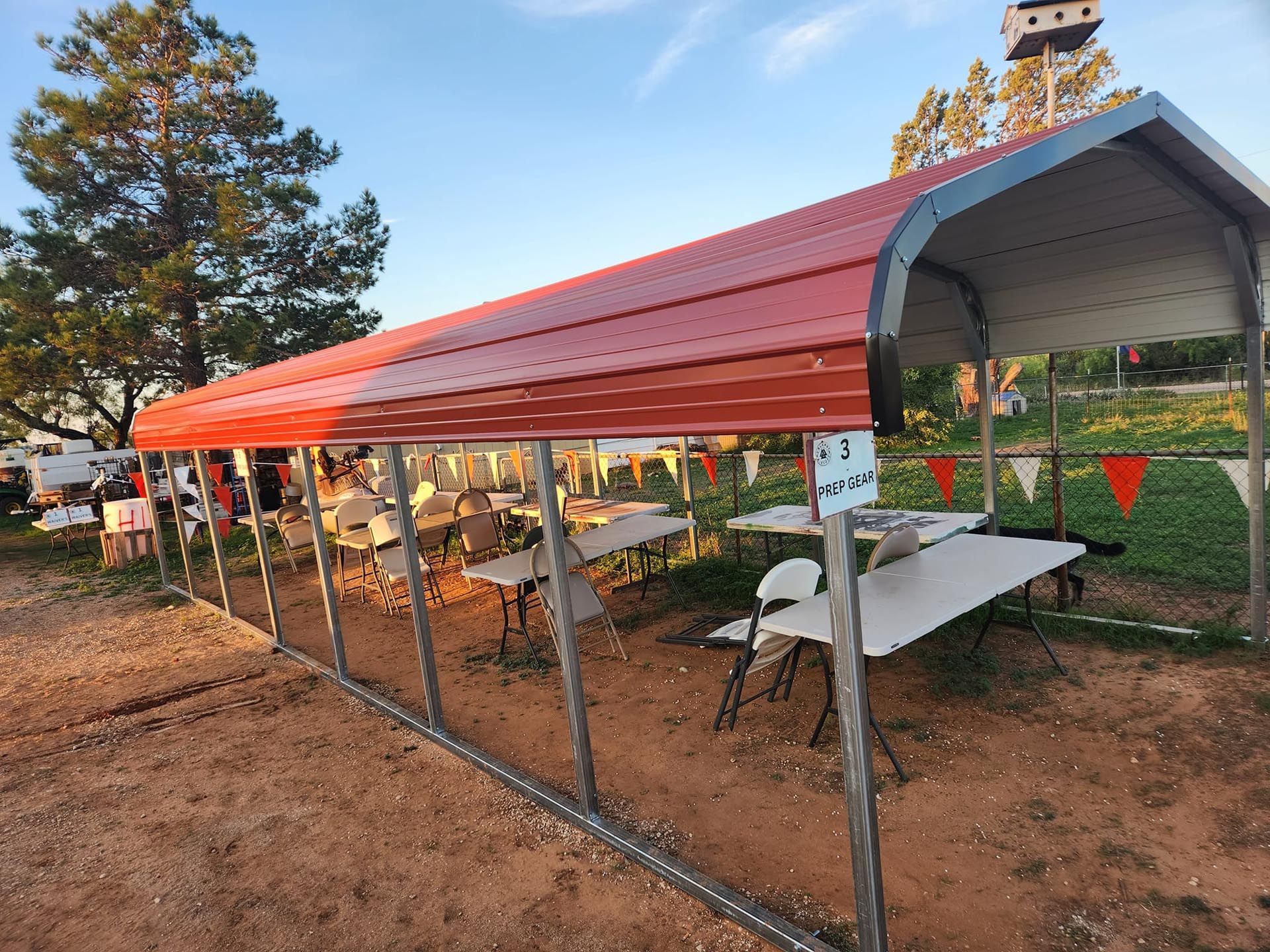 A red canopy with tables and chairs underneath it