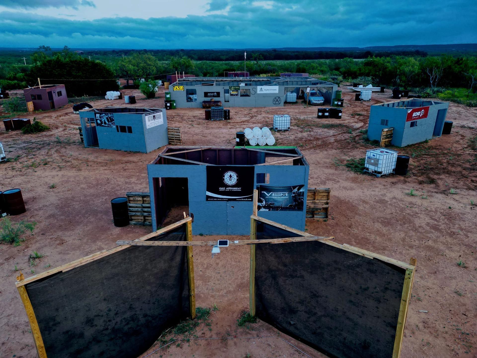 An aerial view of a paintball field with a lot of buildings