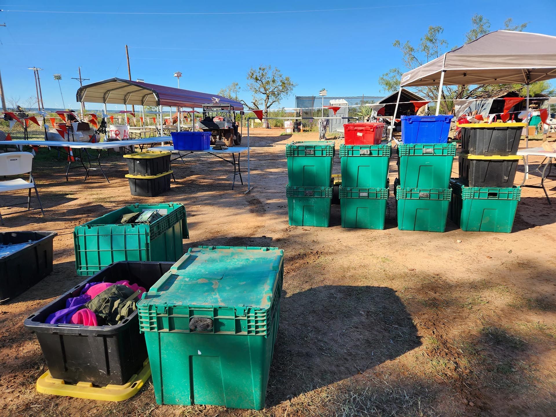 A bunch of green boxes are stacked on top of each other on the ground