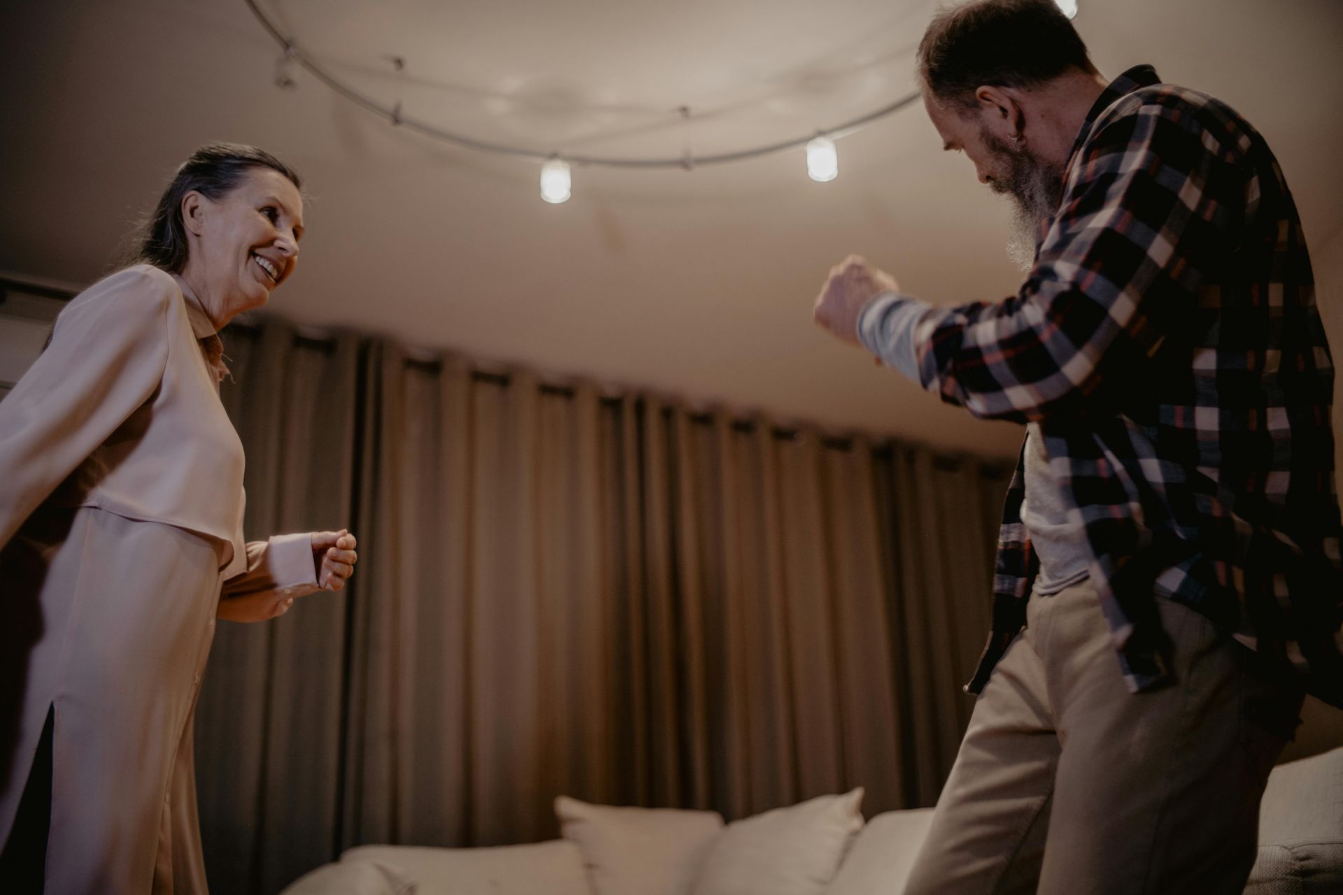 Un homme et une femme dansent ensemble dans un salon.