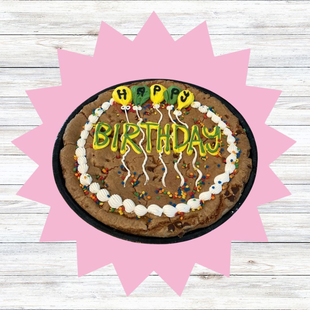 A birthday cake with candles and sprinkles on it