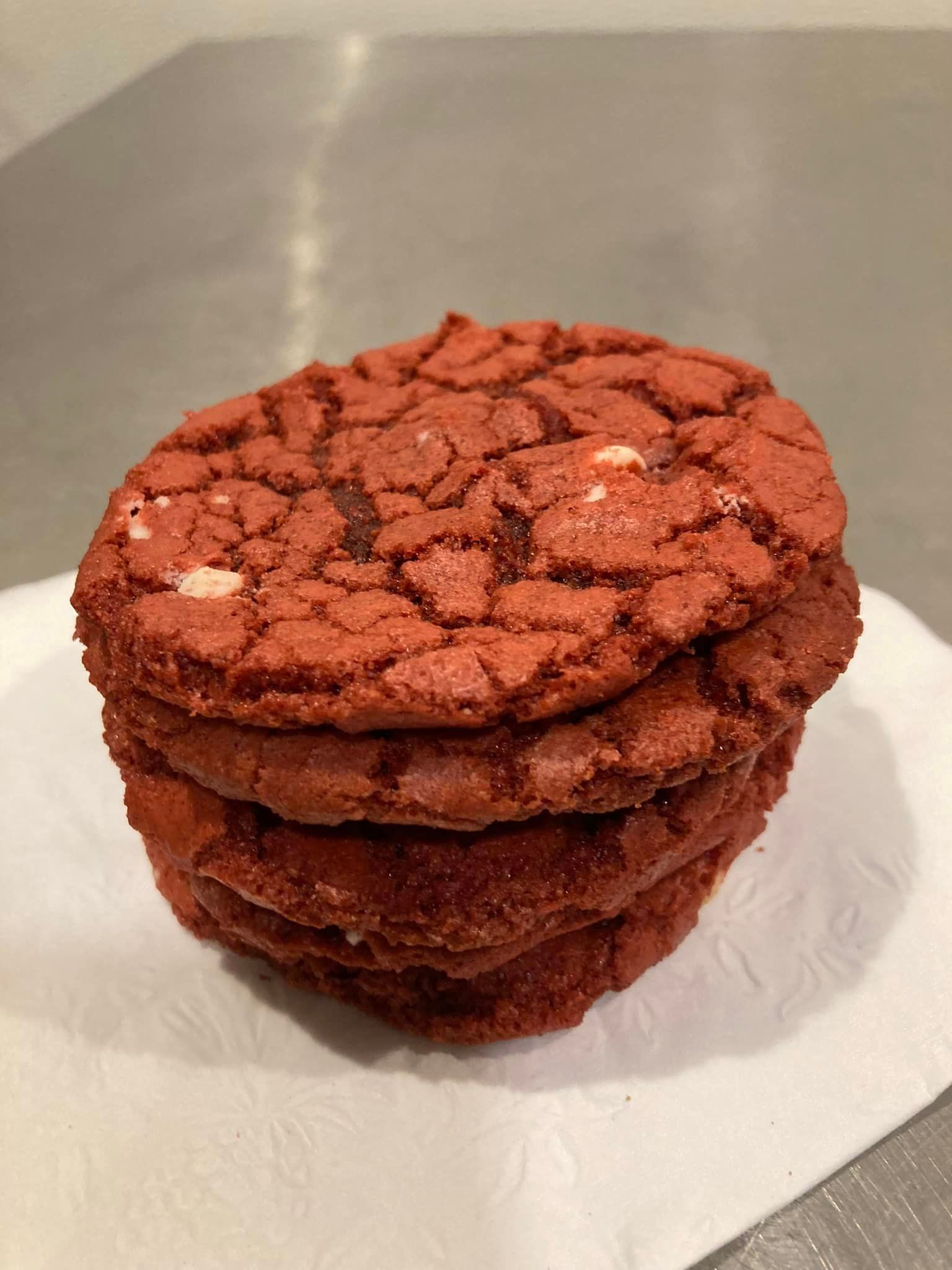 A stack of red velvet cookies on a napkin