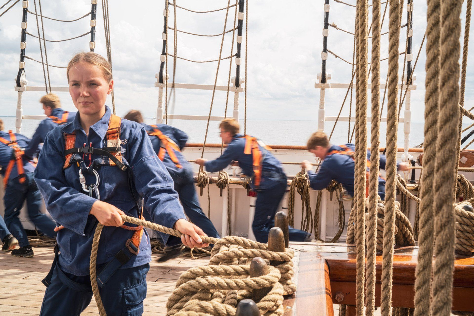 En kvinde trækker i et reb på en båd.