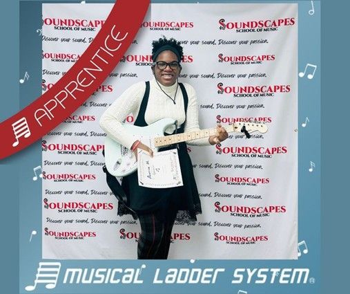 Auria earned her certificate and wristband for 3 months of electric guitar lessons!