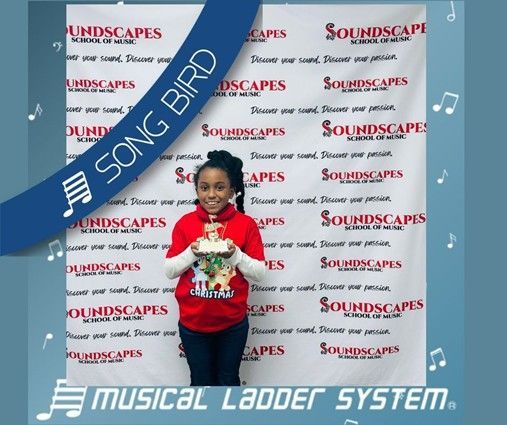 Kyndalyn earned her certificate, wristband, and trophy for 6 months of piano lessons!