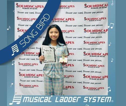 Sophia earned her certificate, wristband, and trophy for 6 months of voice lessons!