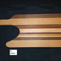 Wooden serving board with various wood tones and handle.