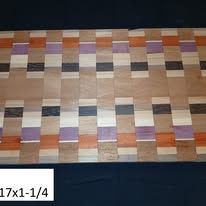 Cutting board with rectangular wood blocks in various colors.
