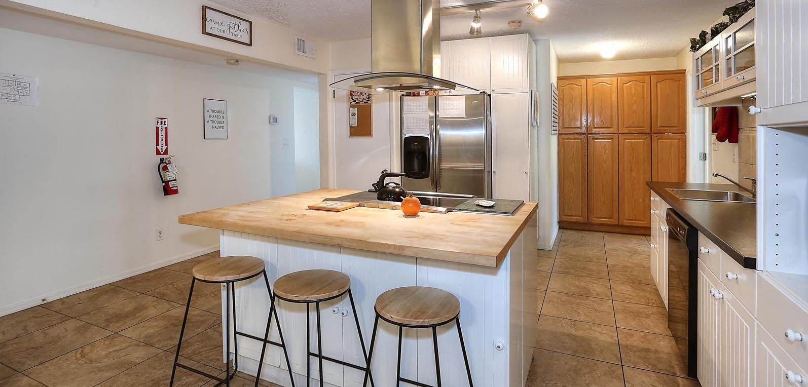 Kitchen A kitchen with a large island and stools