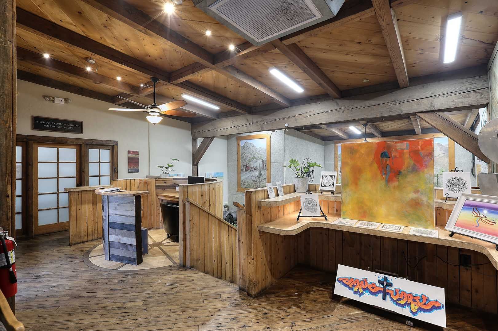 Lobby A large room with a wooden ceiling and a painting on the wall.