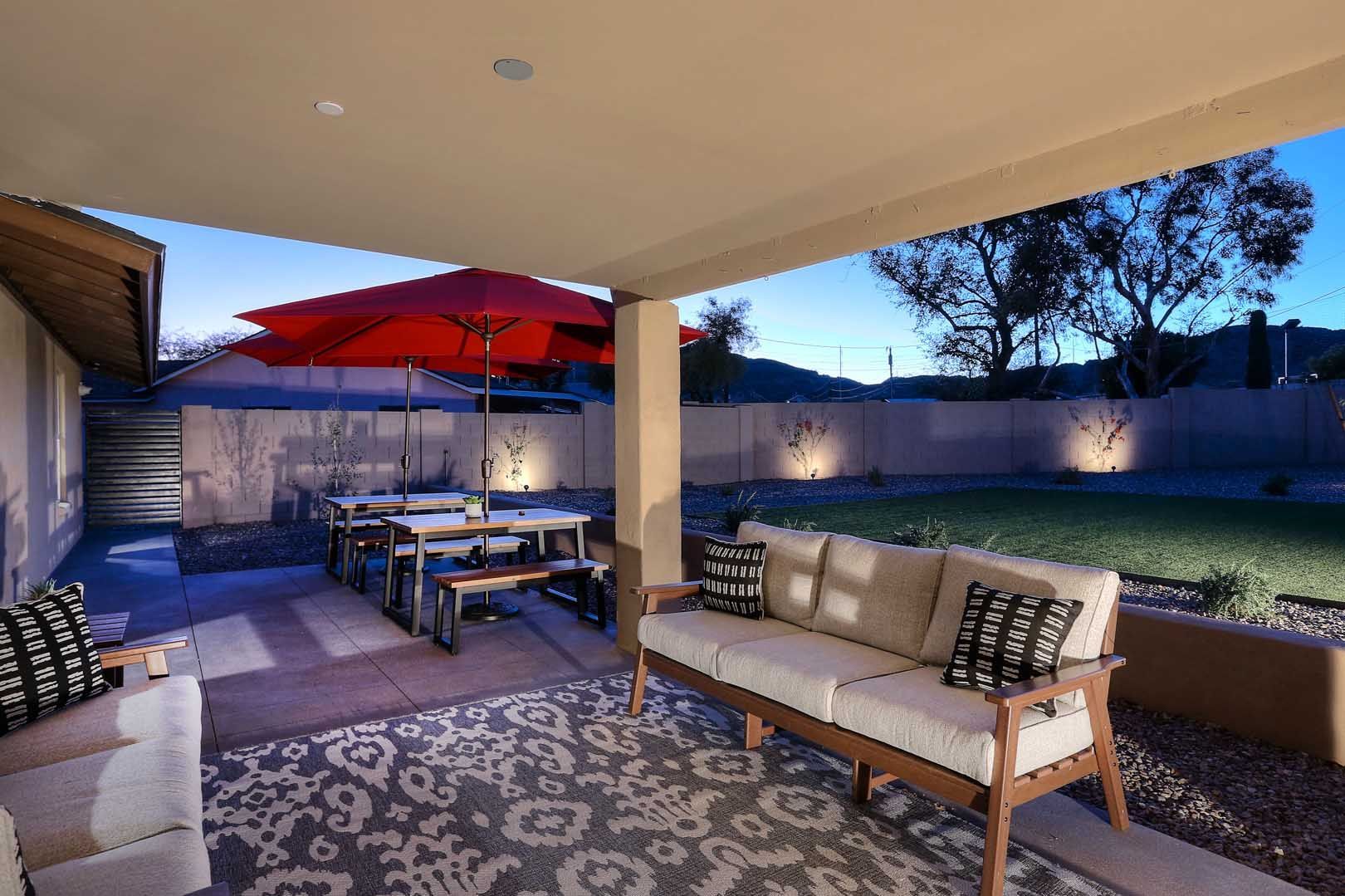 Night-Covered Patio-View-min A patio with a couch , chairs , tables and umbrellas