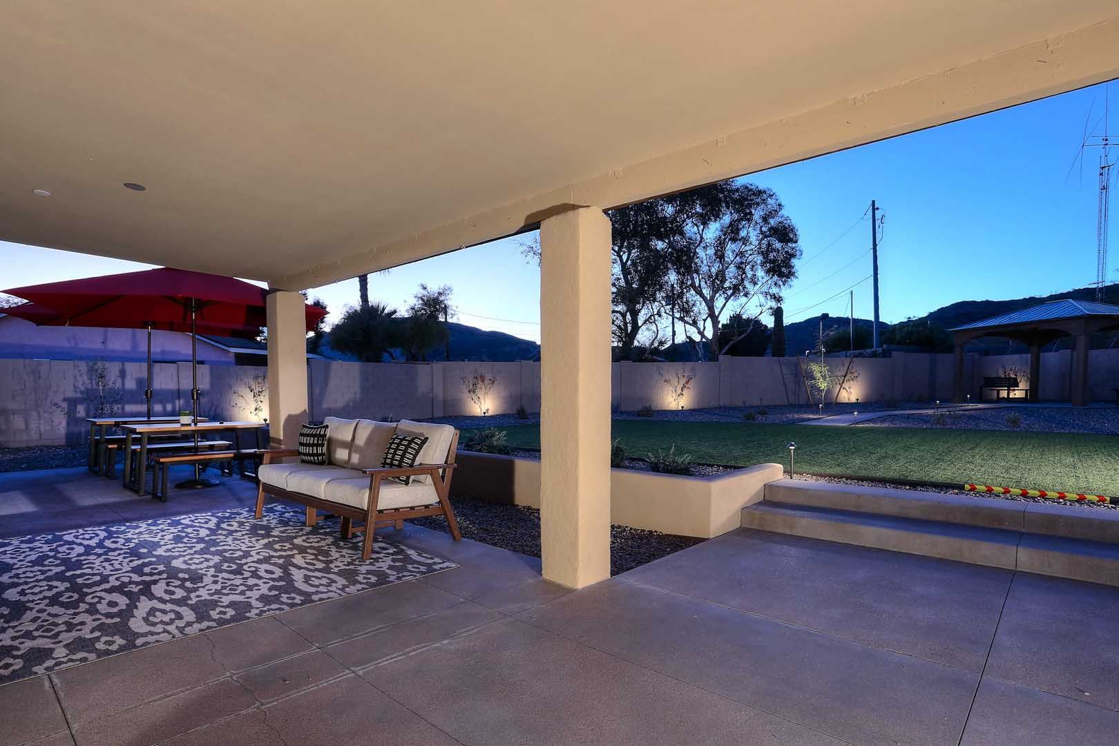 Night-Covered Patio2-min A patio with a couch and umbrellas at night