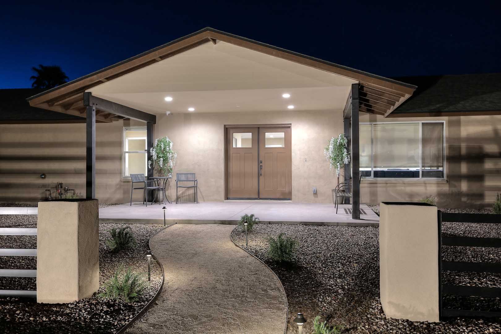 Night-Entry-min A house with a porch and a walkway leading to it at night