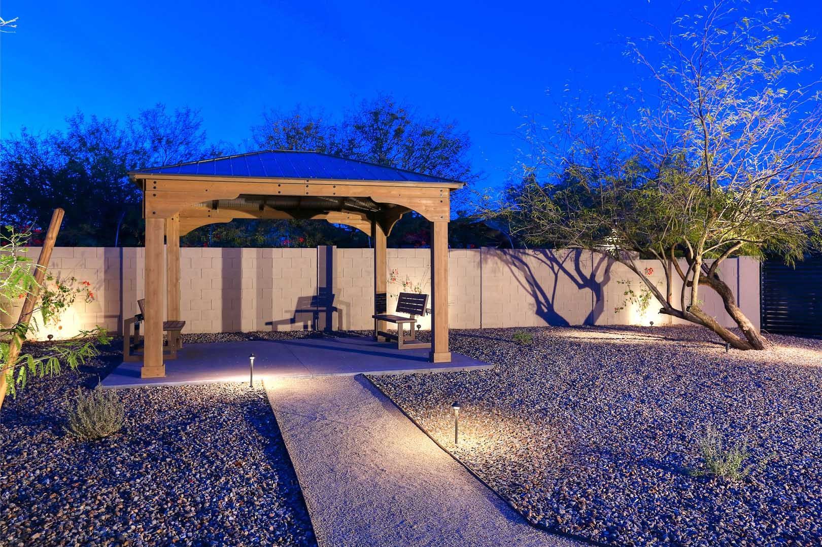 Night-Pergola-min A gazebo is lit up at night in a backyard.
