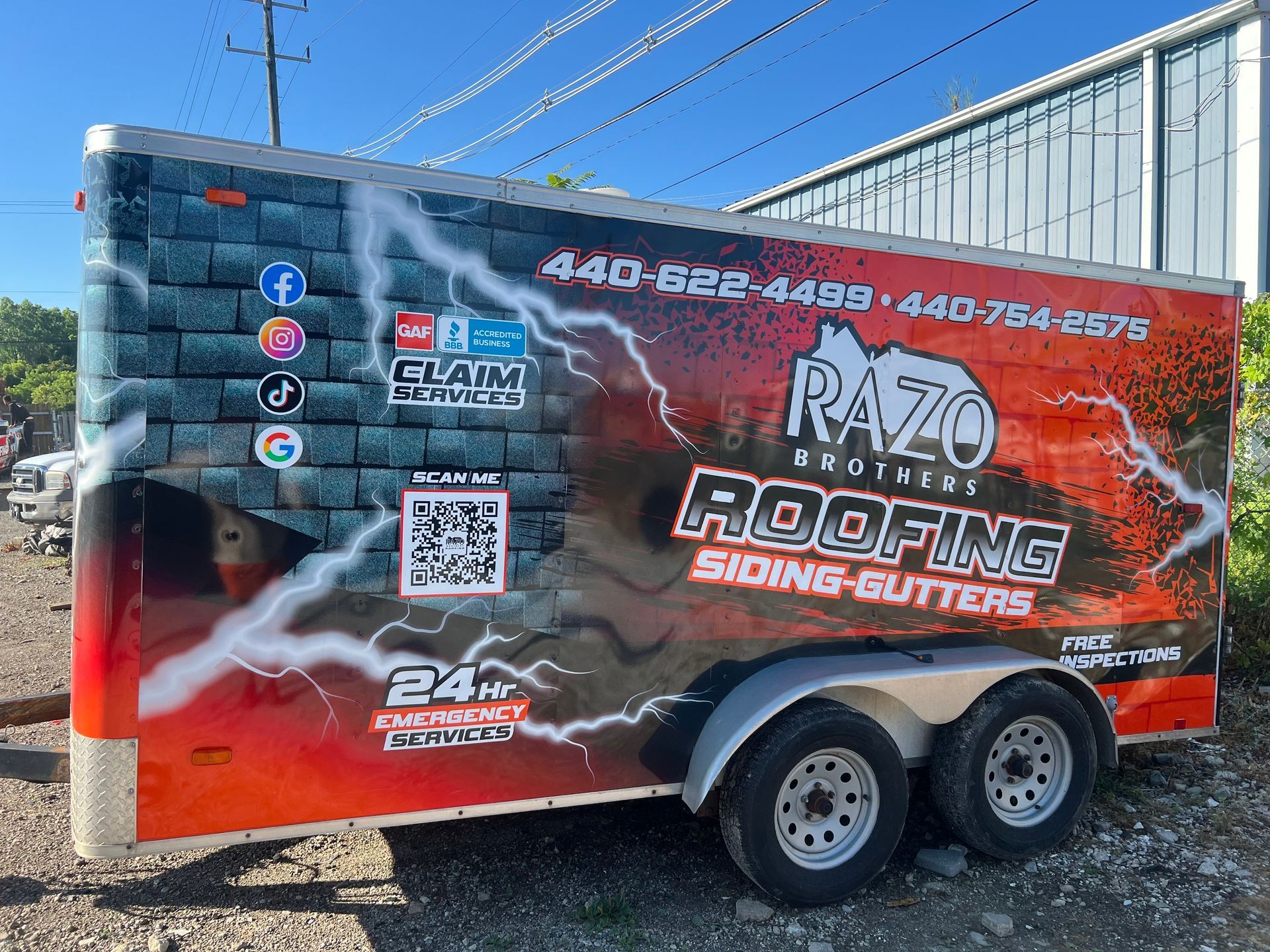A trailer for Razo Brothers Roofing with company details, a brick design, and lightning bolt graphics.