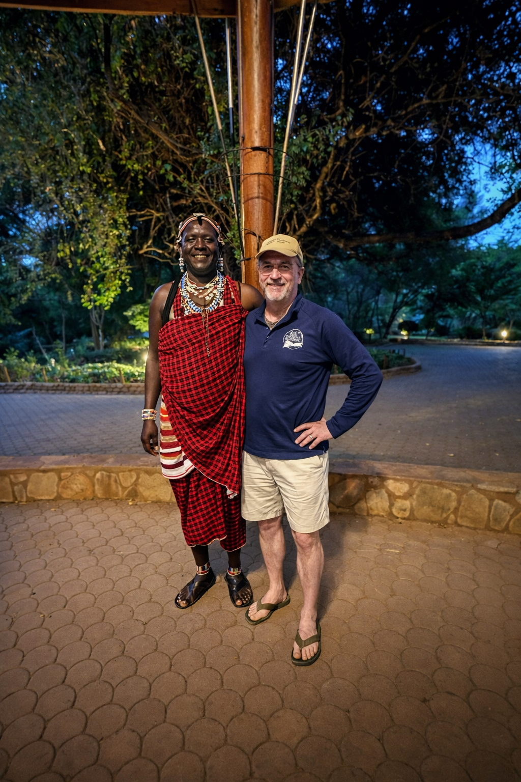 Wooden sign pointing to the beach. Sandy path through dunes. Cloudy sky overhead.