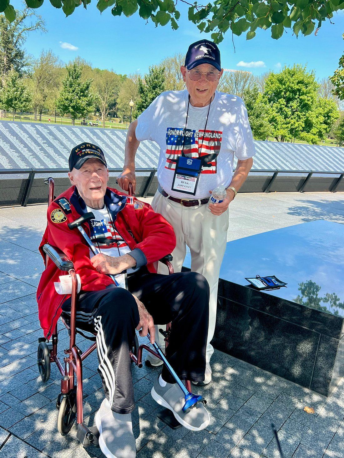 Family stands in front of a tour van with a company logo. A wheelchair symbol is visible.