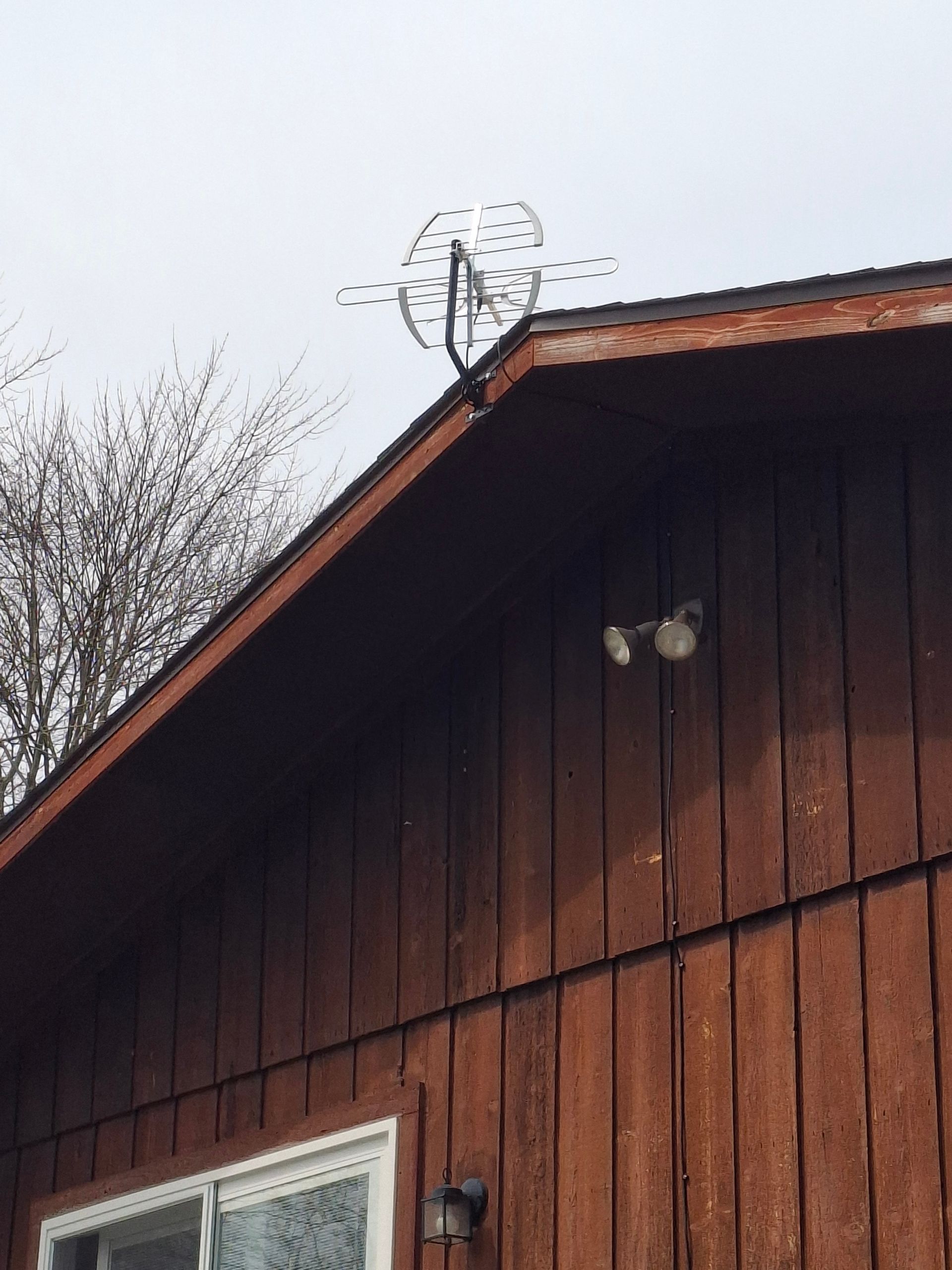 A weather vane on the roof of a house