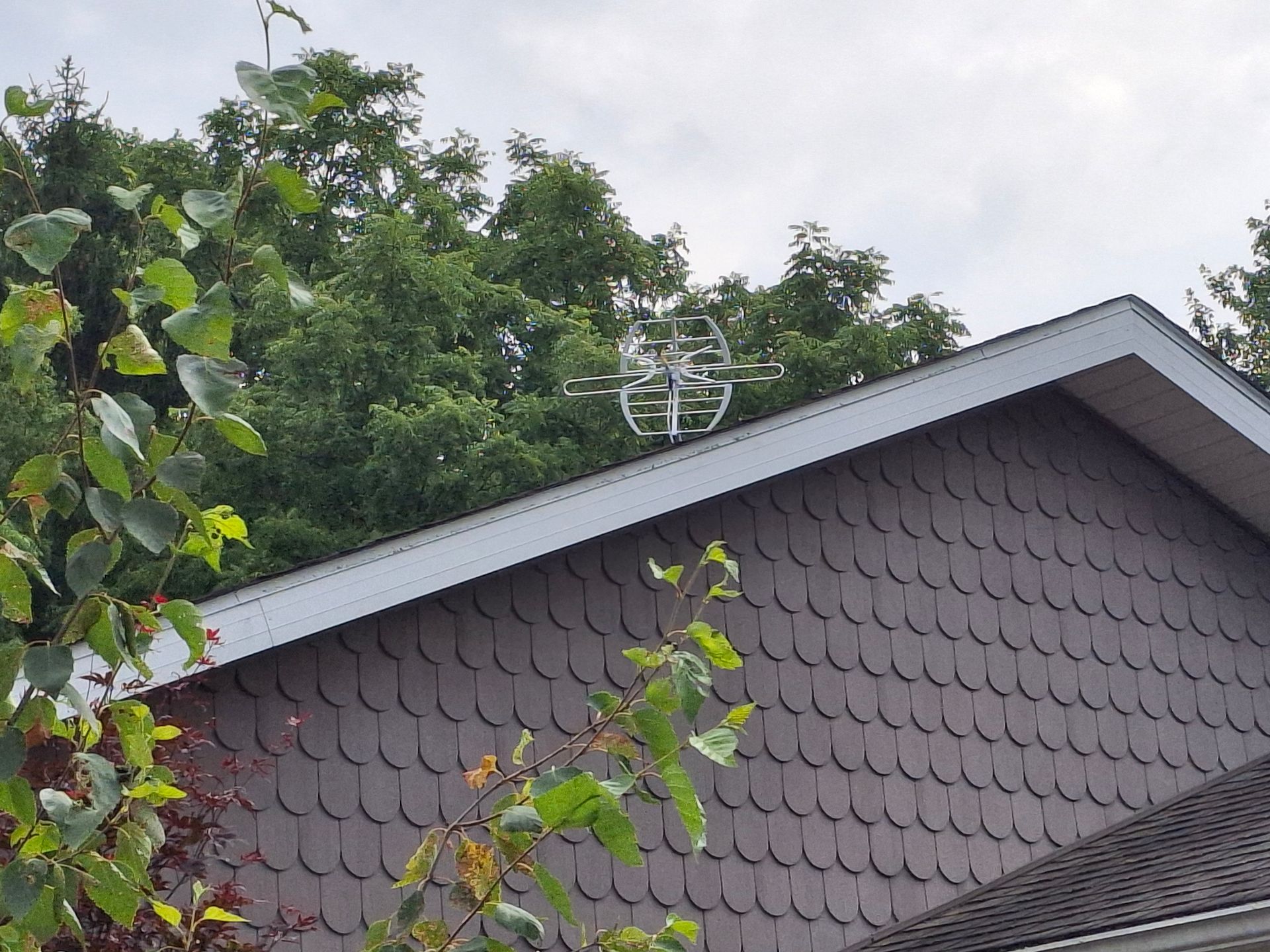 A drone is sitting on the roof of a house