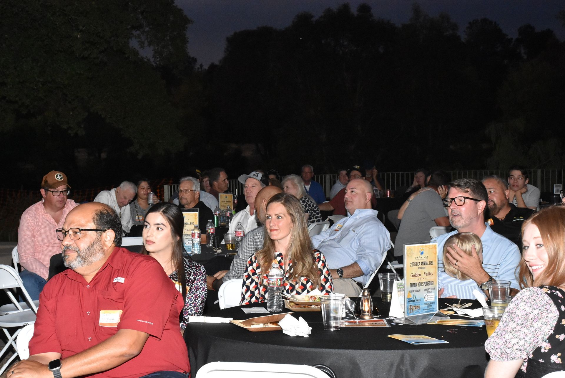 Guests seated at round tables enjoying the evening program at the Oroville Economic Alliance Annual BBQ.