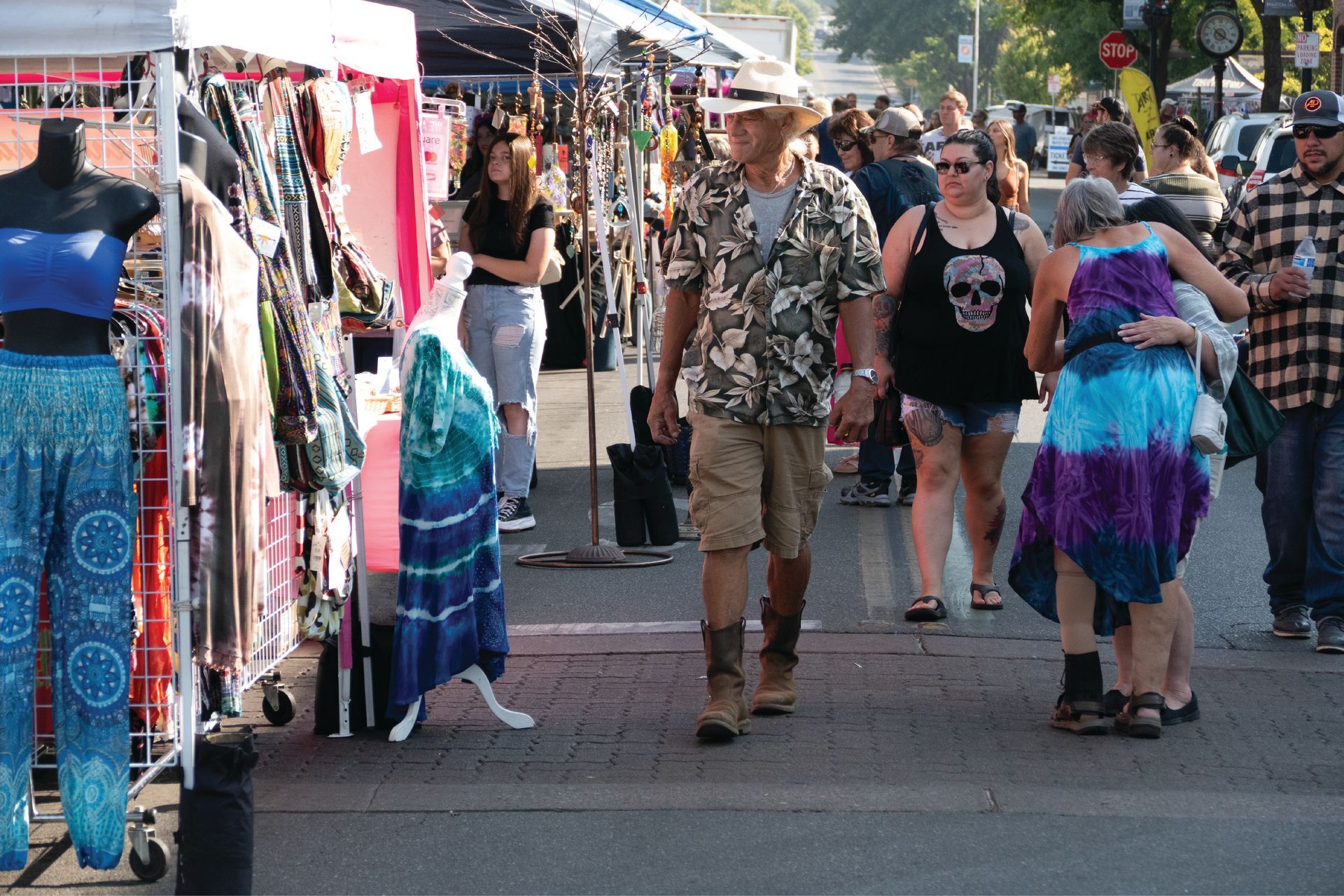 Festival-goers browse colorful clothing and crafts at vendor booths along Downtown Oroville streets during the Salmon Festival.