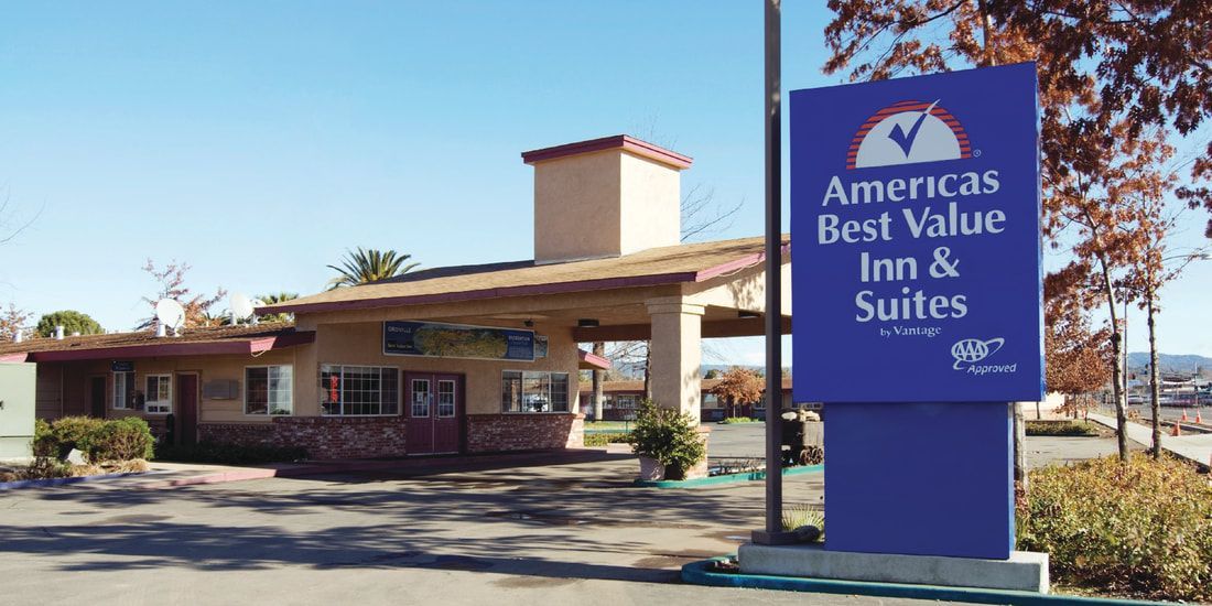 A blue sign for america 's best value inn and suites