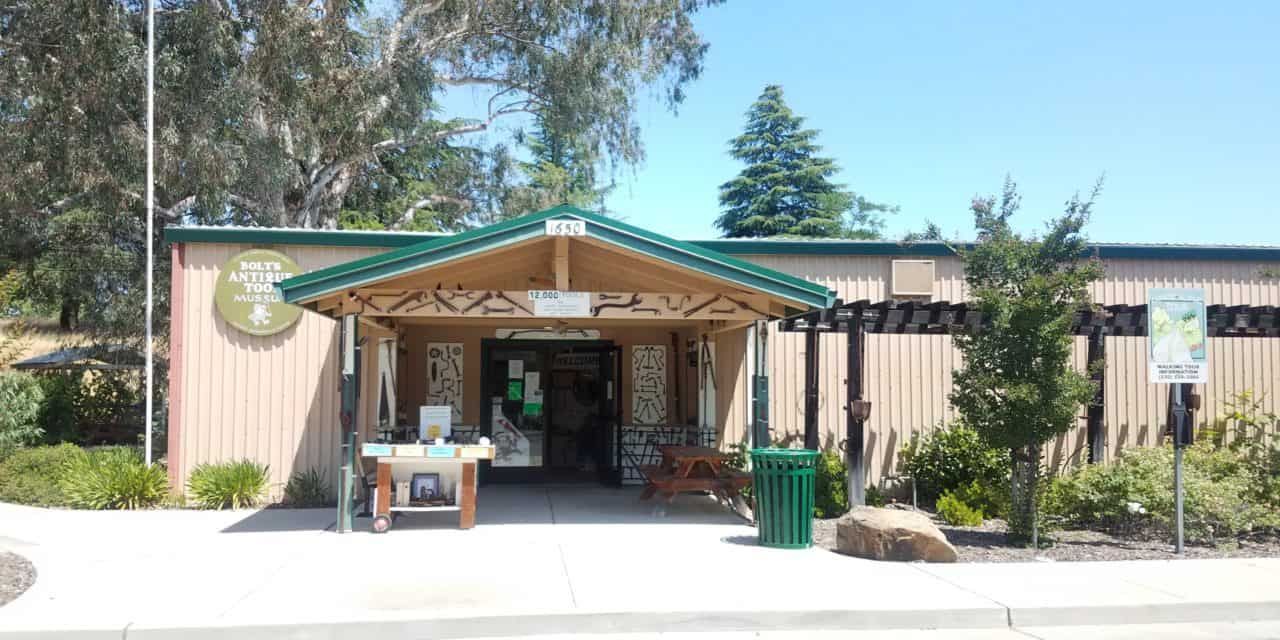 A building with a green roof and a table in front of it.