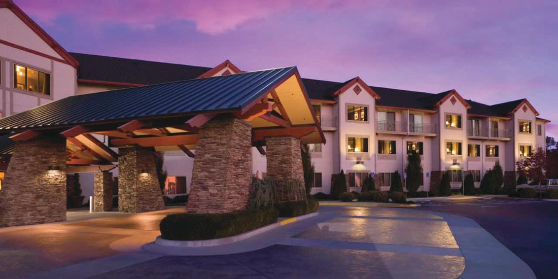 A large hotel with a purple sky in the background